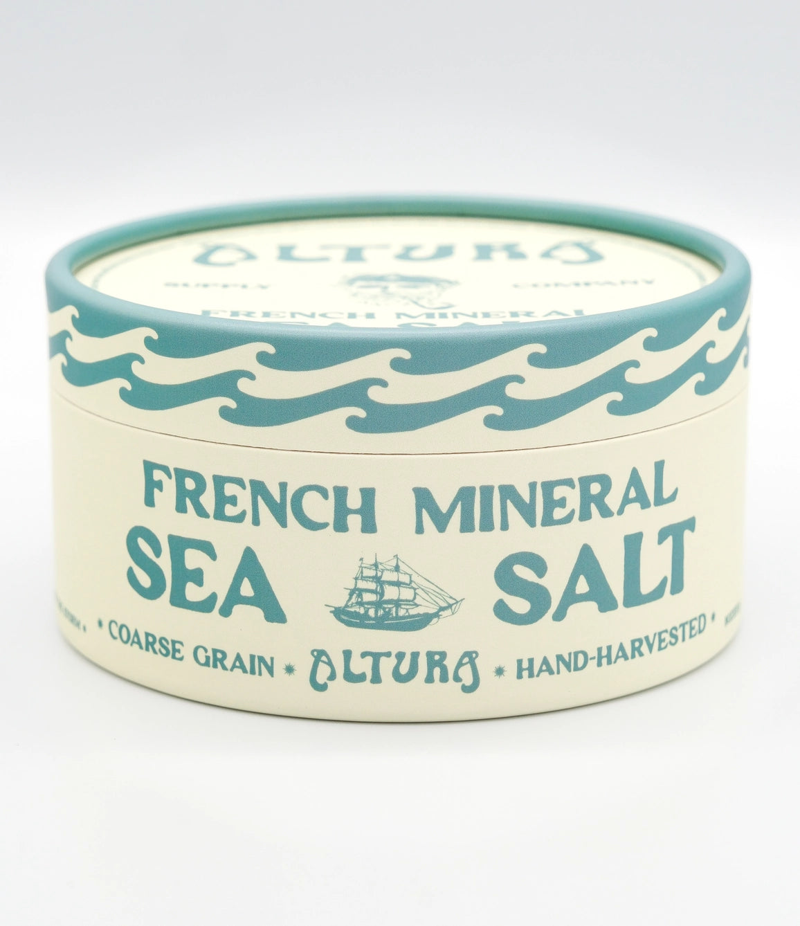A round tin of Altura French Mineral Sea Salt on a clean white background. The tin has a cream-colored body with teal blue text and wave designs, and a matching teal lid.